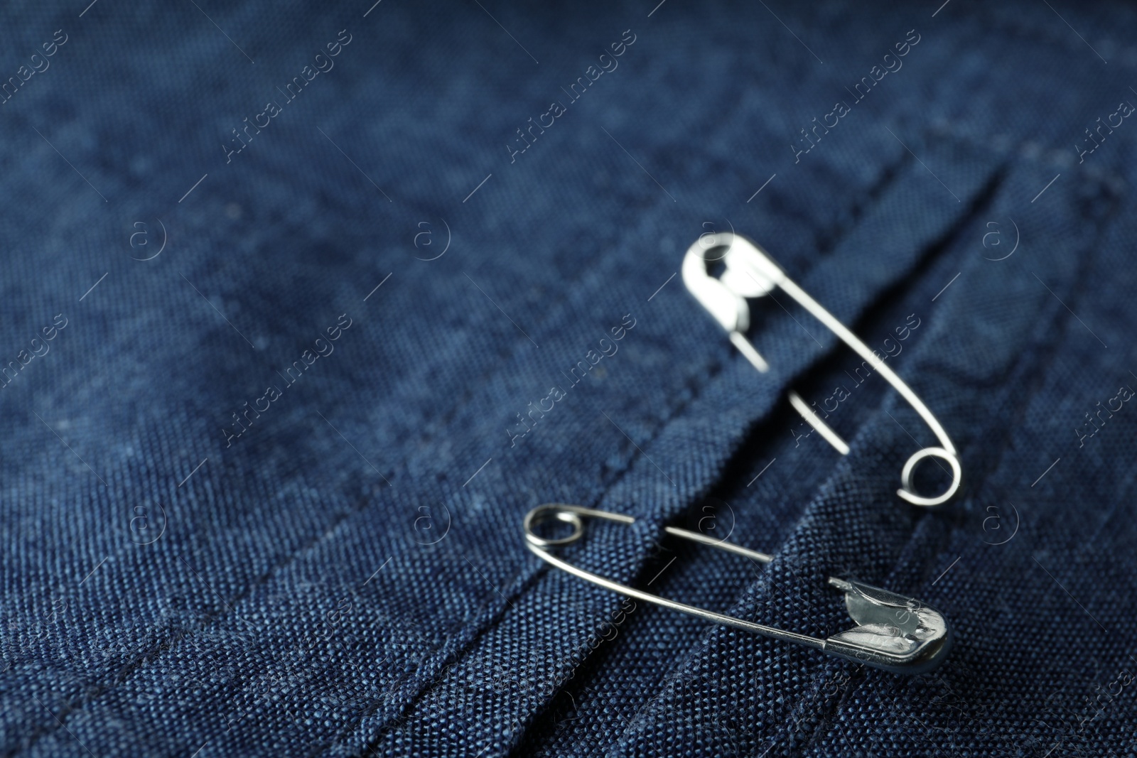 Photo of Closeup view of metal safety pins on clothing