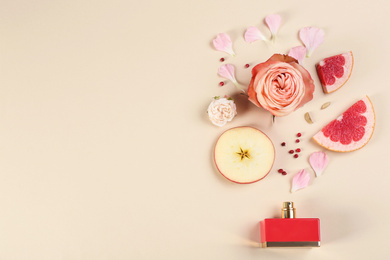 Photo of Flat lay composition with bottle of perfume on beige background, space for text