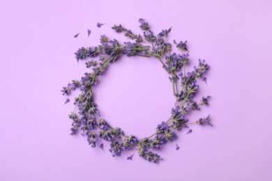 Photo of Frame made with lavender flowers on violet background, flat lay. Space for text
