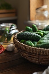 Photo of Fresh cucumbers on wooden table, closeup. Pickling vegetables