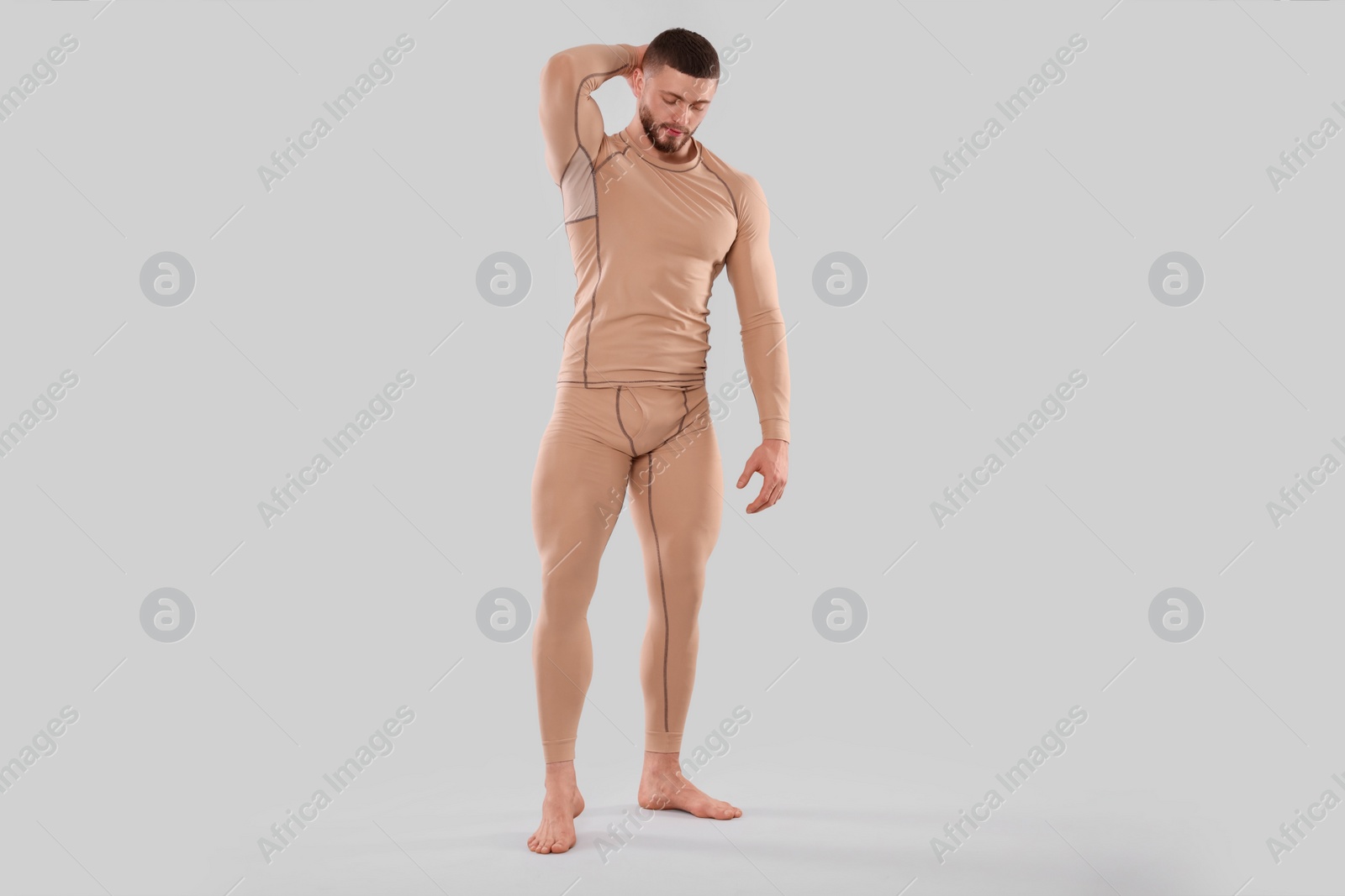 Photo of Man in warm thermal underwear on light background. Space for text