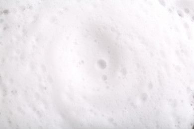 Photo of White foam with bubbles as background, top view