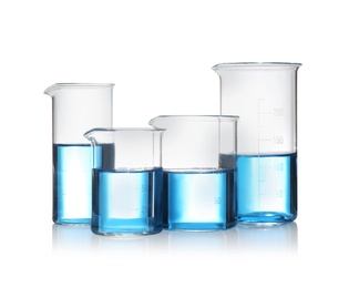 Beakers with blue liquid isolated on white. Laboratory glassware