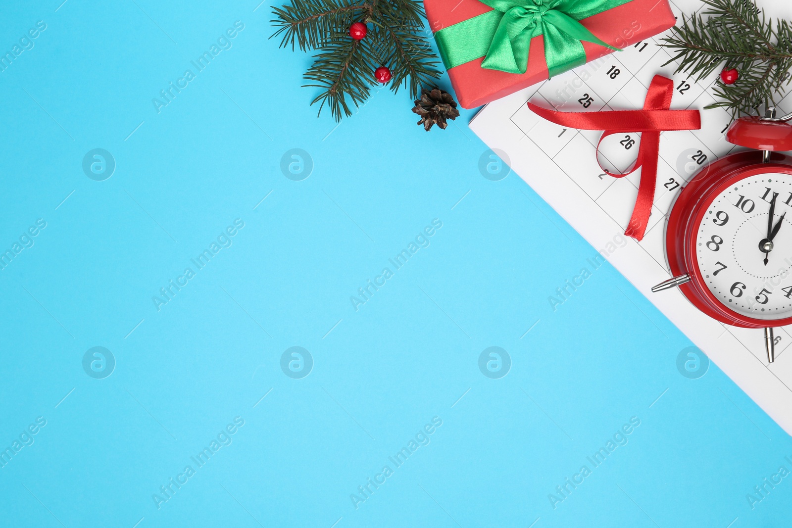 Photo of Flat lay composition with calendar and alarm clock on light blue background, space for text. Boxing Day