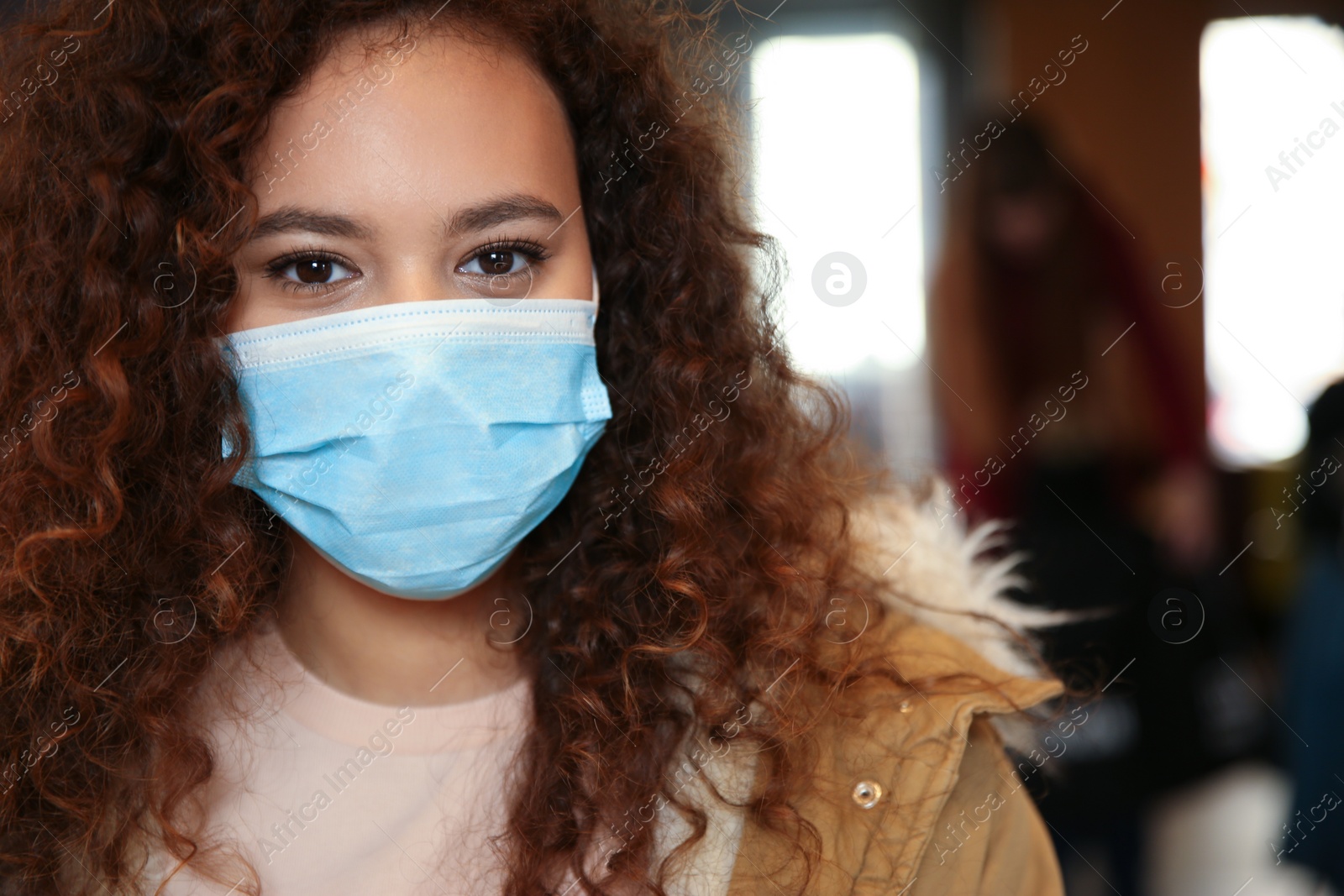 Photo of African-American woman with disposable mask indoors. Virus protection