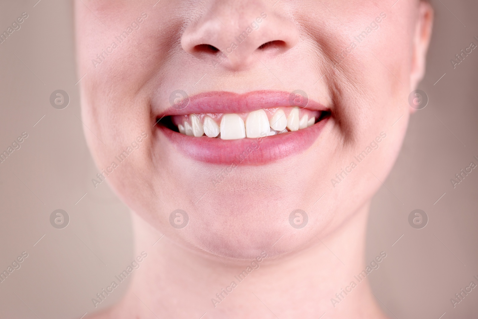 Photo of Young woman with healthy teeth smiling on color background, closeup