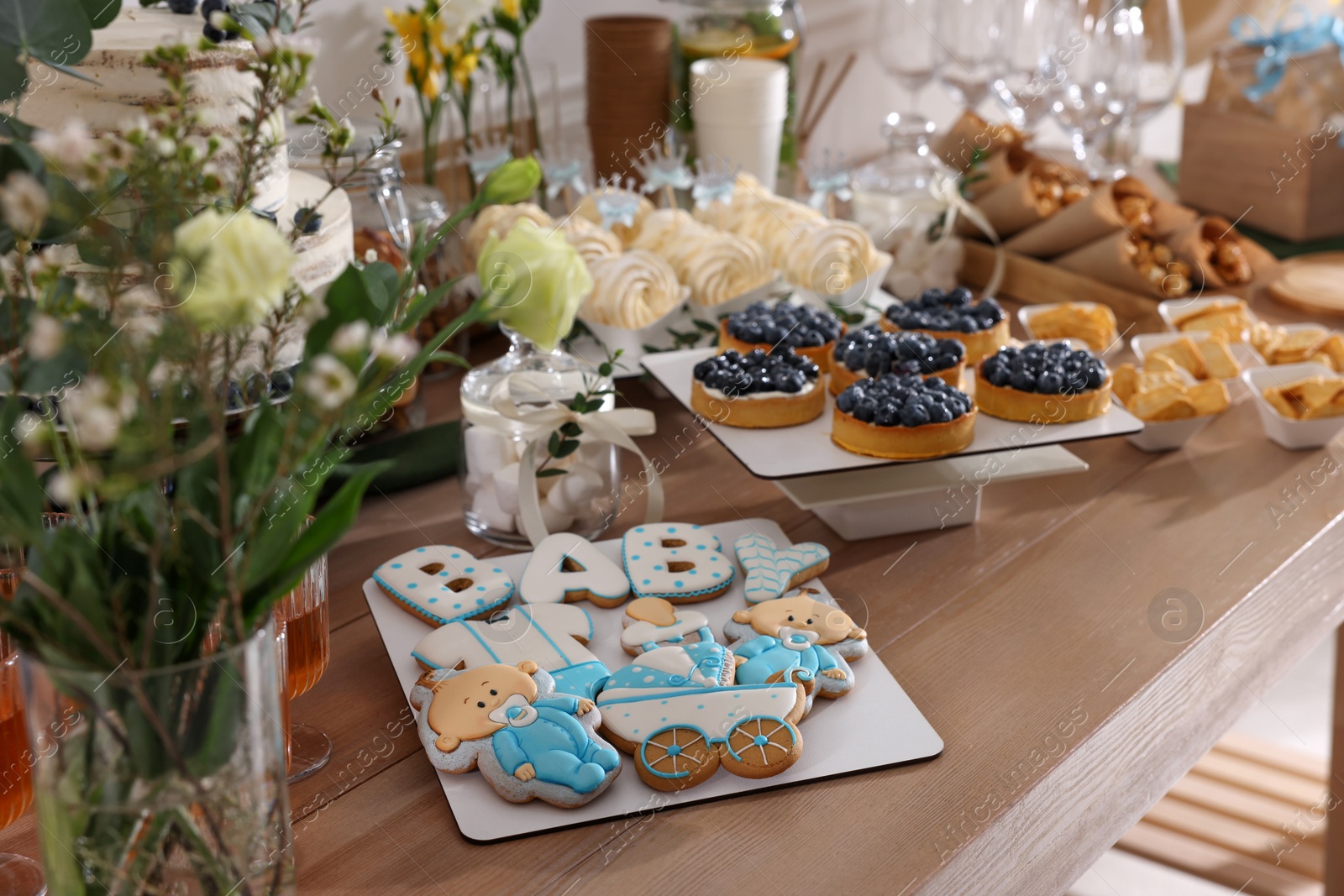 Photo of Tasty treats on table in room. Baby shower party