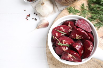 Flat lay composition with raw beetroot slices on white wooden table. Space for text