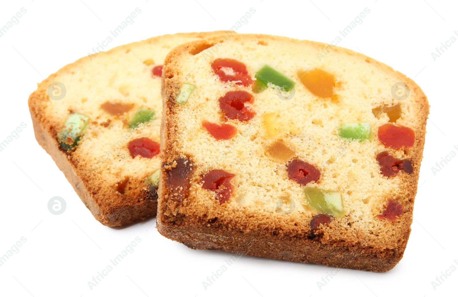 Photo of Slices of delicious cake with candied fruits on white background