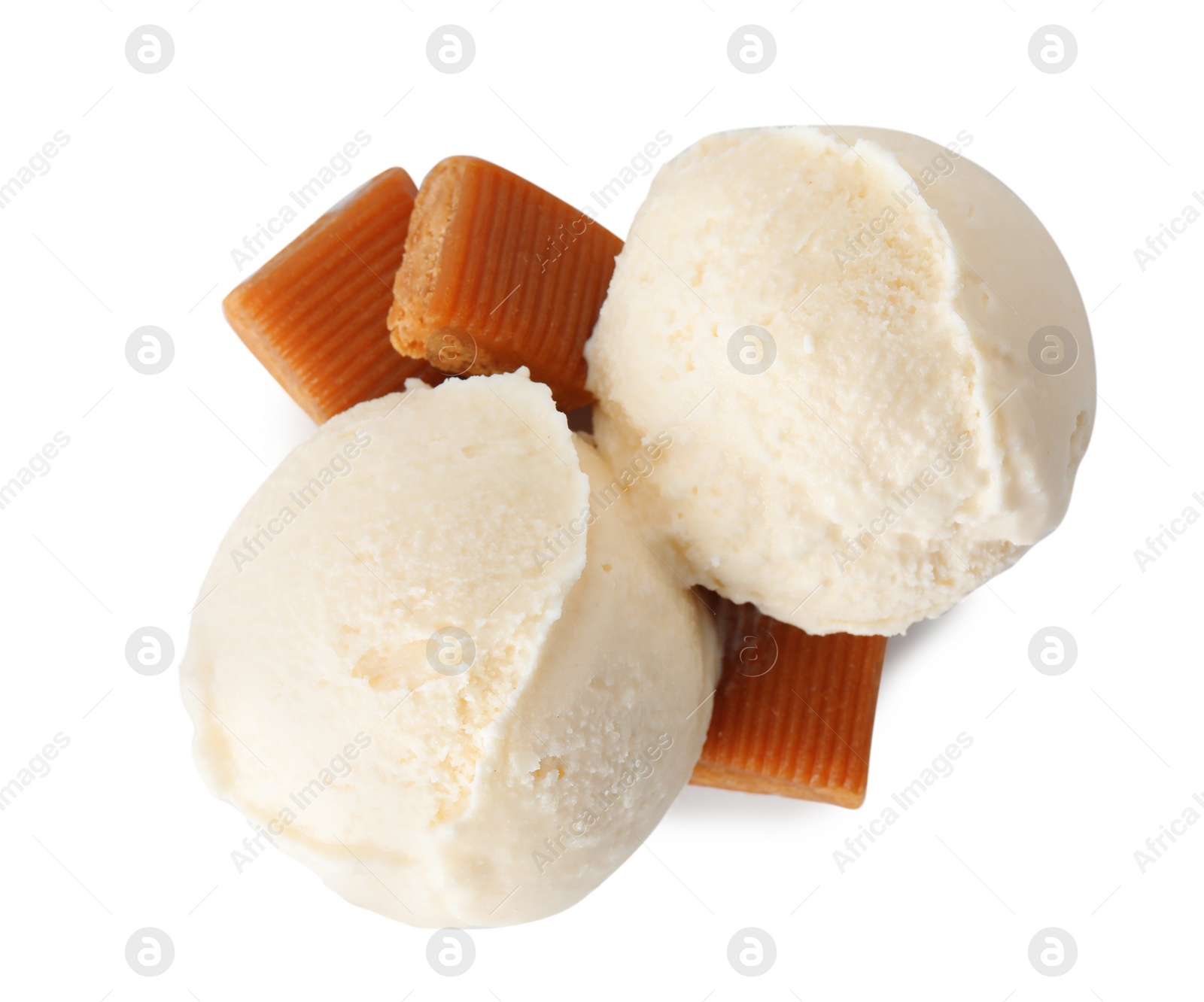 Photo of Scoops of delicious ice cream with caramel candies on white background, top view