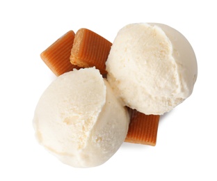 Photo of Scoops of delicious ice cream with caramel candies on white background, top view