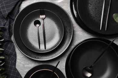 Photo of Stylish table setting with cutlery on grey surface, flat lay