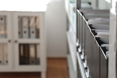 Photo of Folders with documents on shelf in archive. Space for text