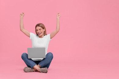 Photo of Emotional woman with laptop on pink background. Space for text