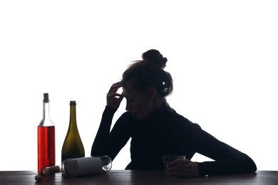 Photo of Alcohol addiction. Woman with glass and bottles on white background