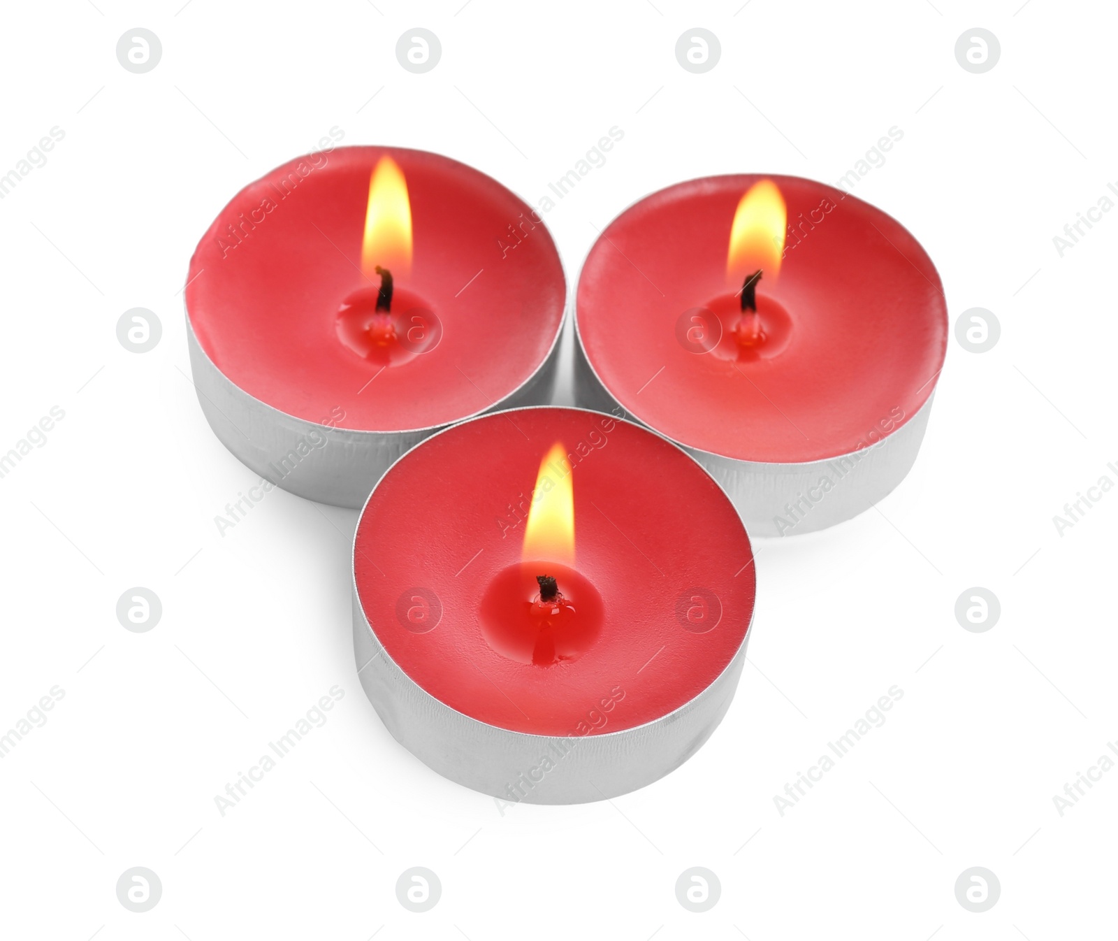 Photo of Colorful wax candles burning on white background