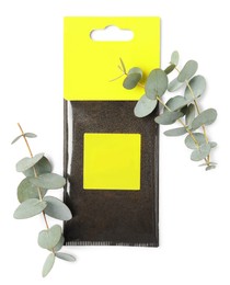 Photo of Scented sachet and eucalyptus branches on white background, top view