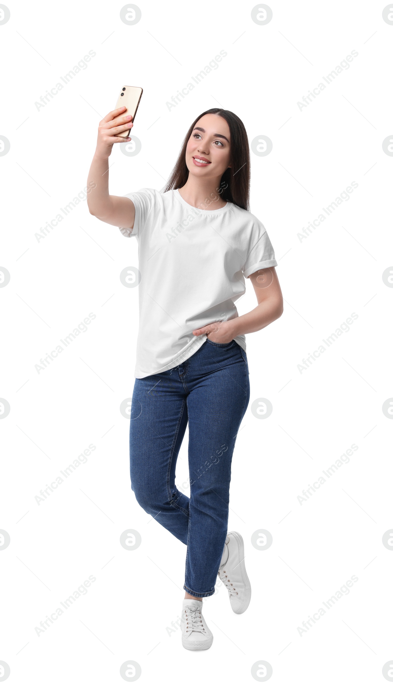 Photo of Smiling young woman taking selfie with smartphone on white background