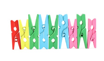 Photo of Many colorful wooden clothespins on white background