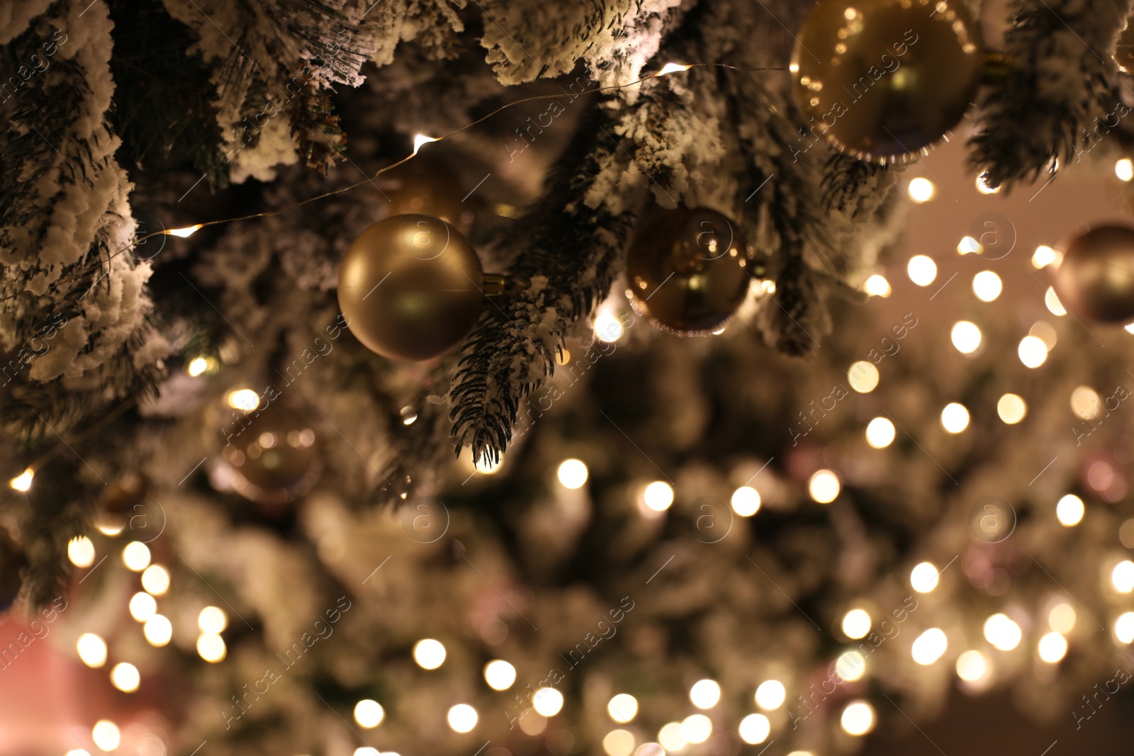 Photo of Closeup view of beautifully decorated Christmas tree indoors