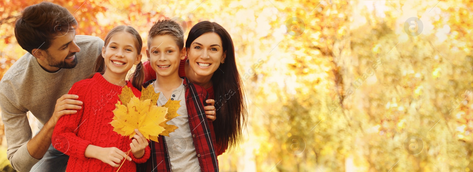 Image of Autumn walk. Happy family with children spending time in park on sunny day, space for text. Banner design