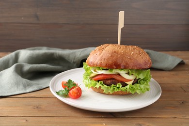 Photo of Delicious vegetarian burger served on wooden table