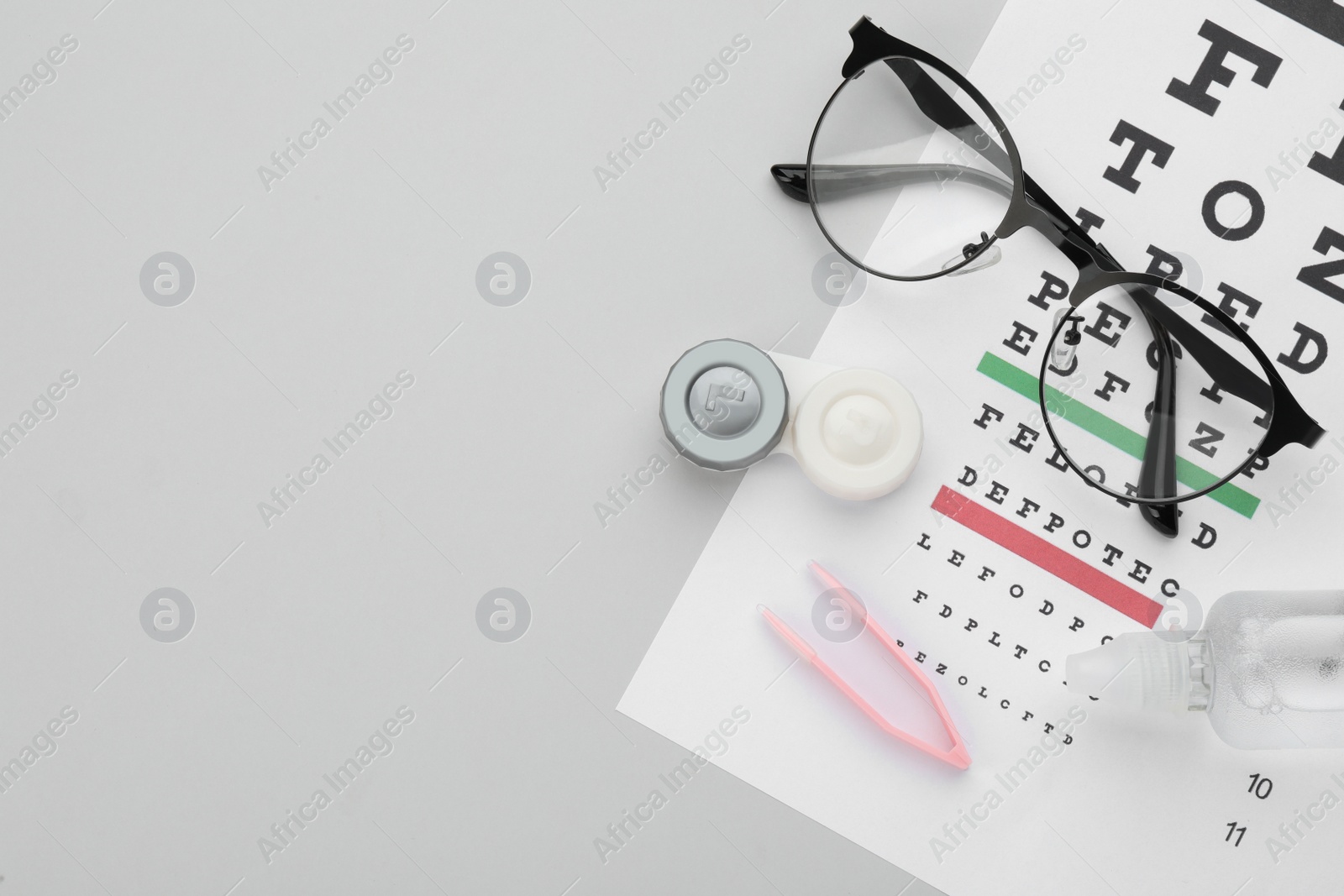 Photo of Composition with contact lenses on light grey background, top view. Space for text