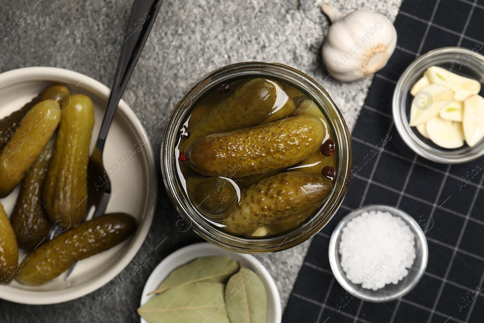 Photo of Tasty pickled cucumbers and spices on table, flat lay