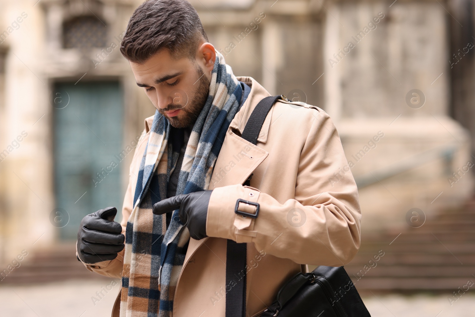 Photo of Handsome man in warm scarf on city street