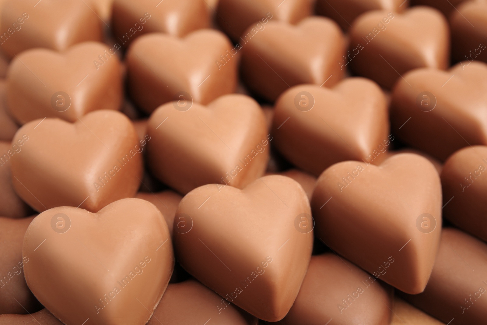 Photo of Tasty heart shaped chocolate candies as background, closeup. Valentine's day celebration