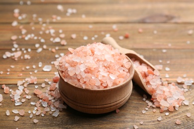 Photo of Pink himalayan salt in bowl on wooden table