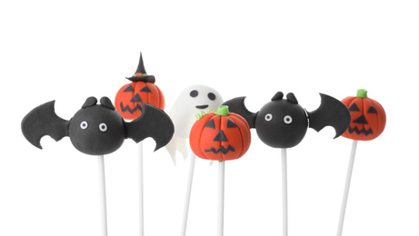 Different Halloween themed cake pops on white background