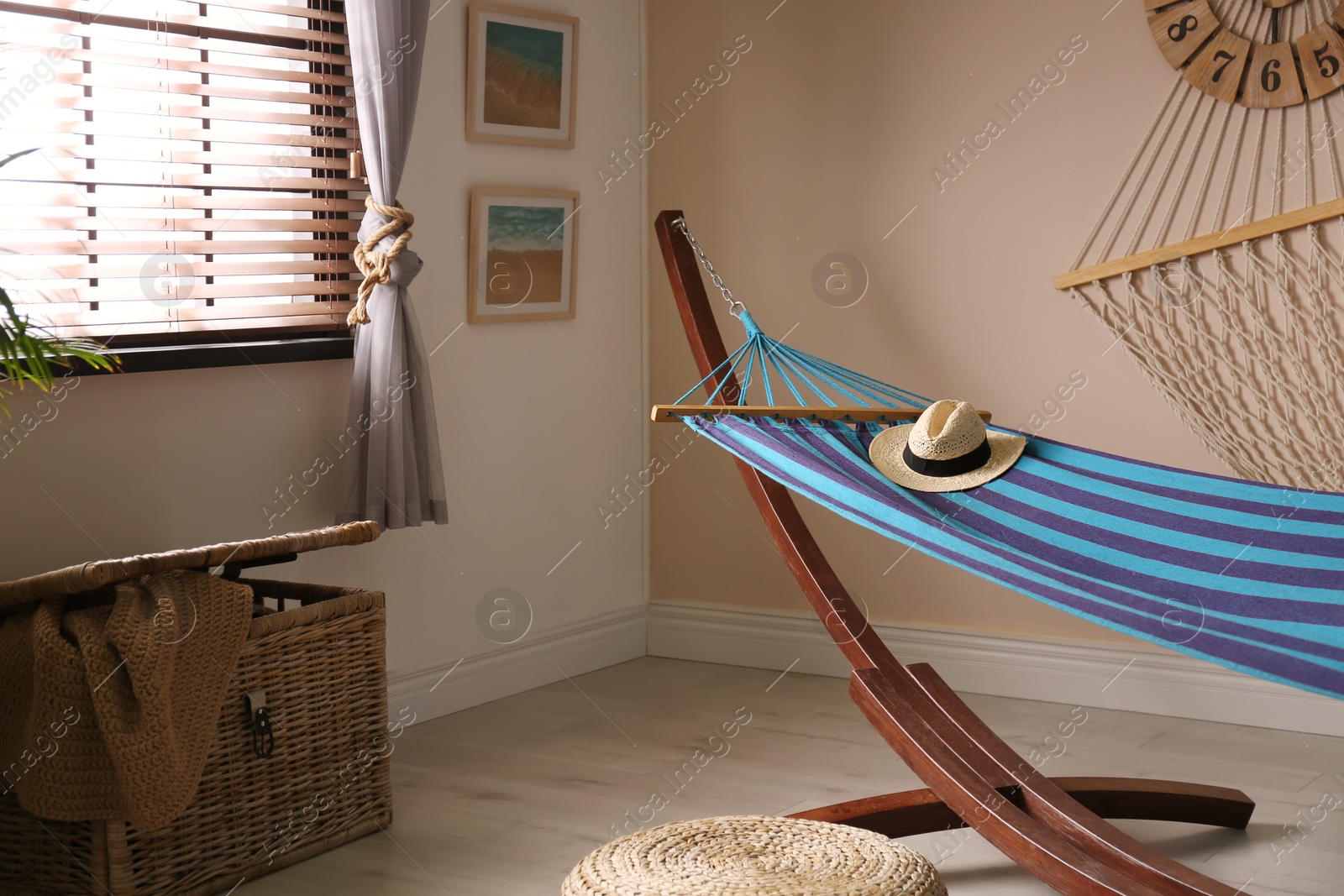 Photo of Comfortable blue hammock in stylish room. Interior design