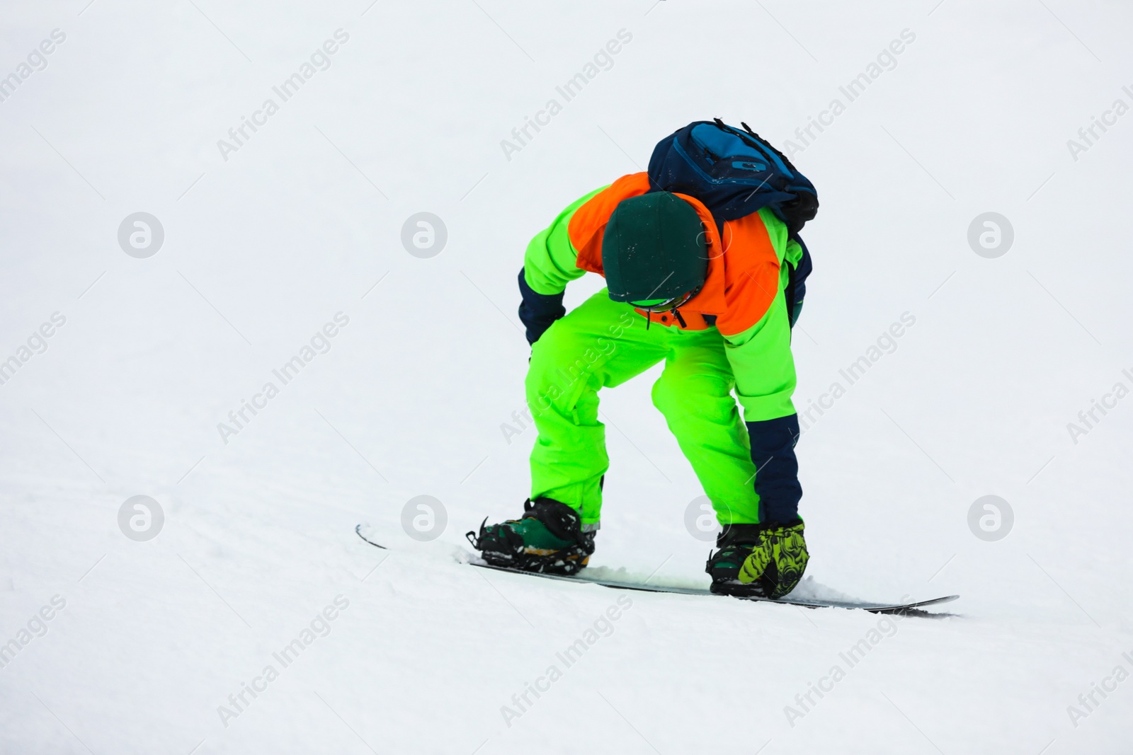 Photo of Snowboarder on slope at resort. Winter vacation