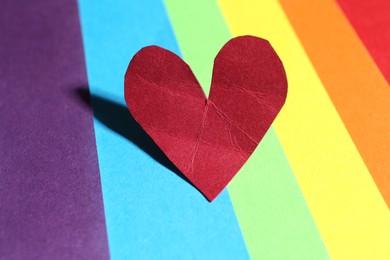 Photo of Red crumpled paper heart on colorful background. Breakup concept