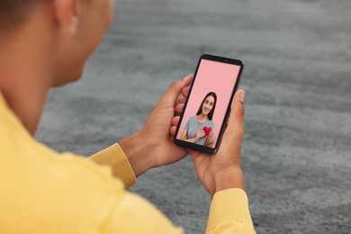 Image of Long distance love. Man having video chat with his girlfriend via smartphone at home, closeup