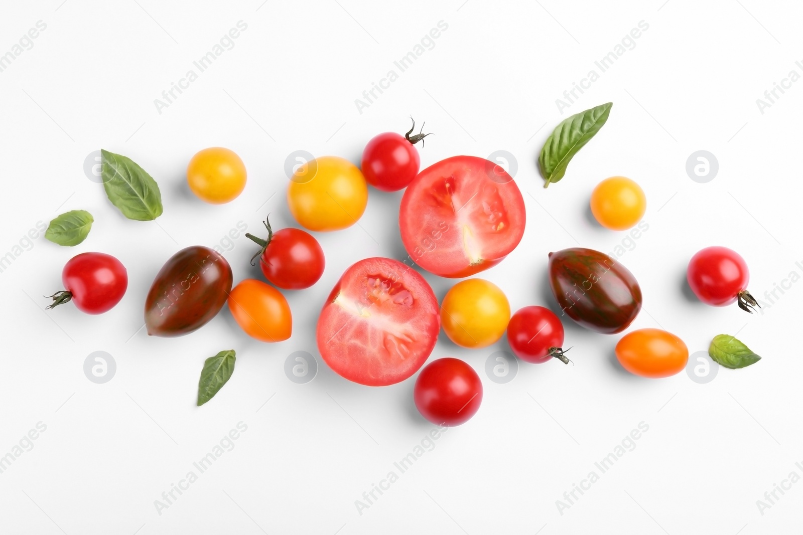 Photo of Flat lay composition with different whole and cut tomatoes on white background