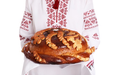 Woman with korovai on white background, closeup. Ukrainian bread and salt welcoming tradition