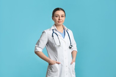 Pediatrician in uniform with stethoscope on turquoise background