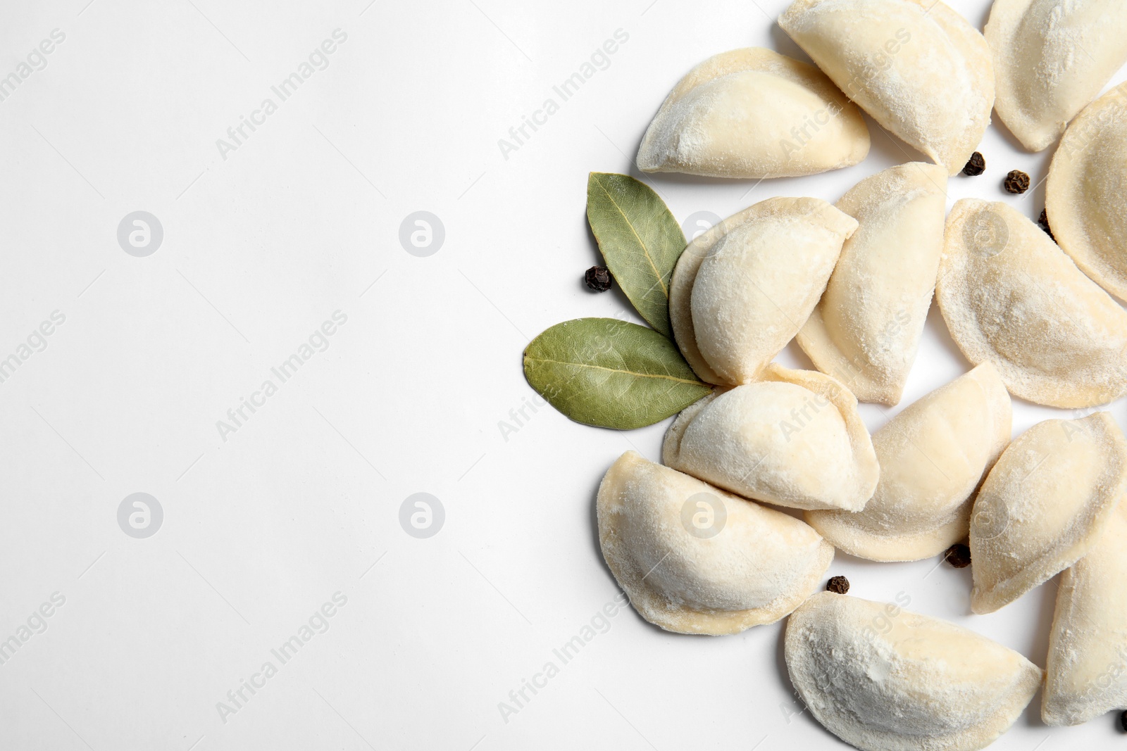 Photo of Raw dumplings on white background, top view. Home cooking