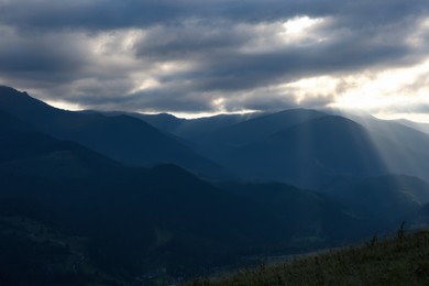 Beautiful mountains under cloudy sky at sunset. Picturesque landscape