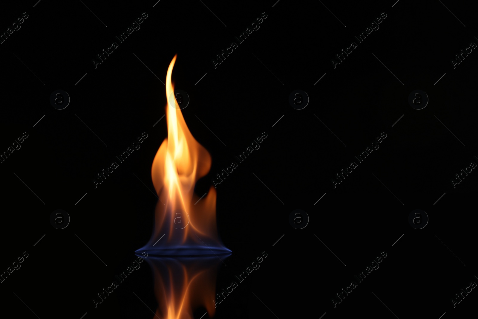 Photo of Beautiful view of flaming vodka on black background