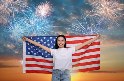 Image of 4th of July - Independence day of America. Happy woman holding national flag of United States against sky with fireworks