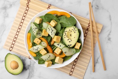 Photo of Tasty salad with tofu and vegetables served on white marble table, flat lay
