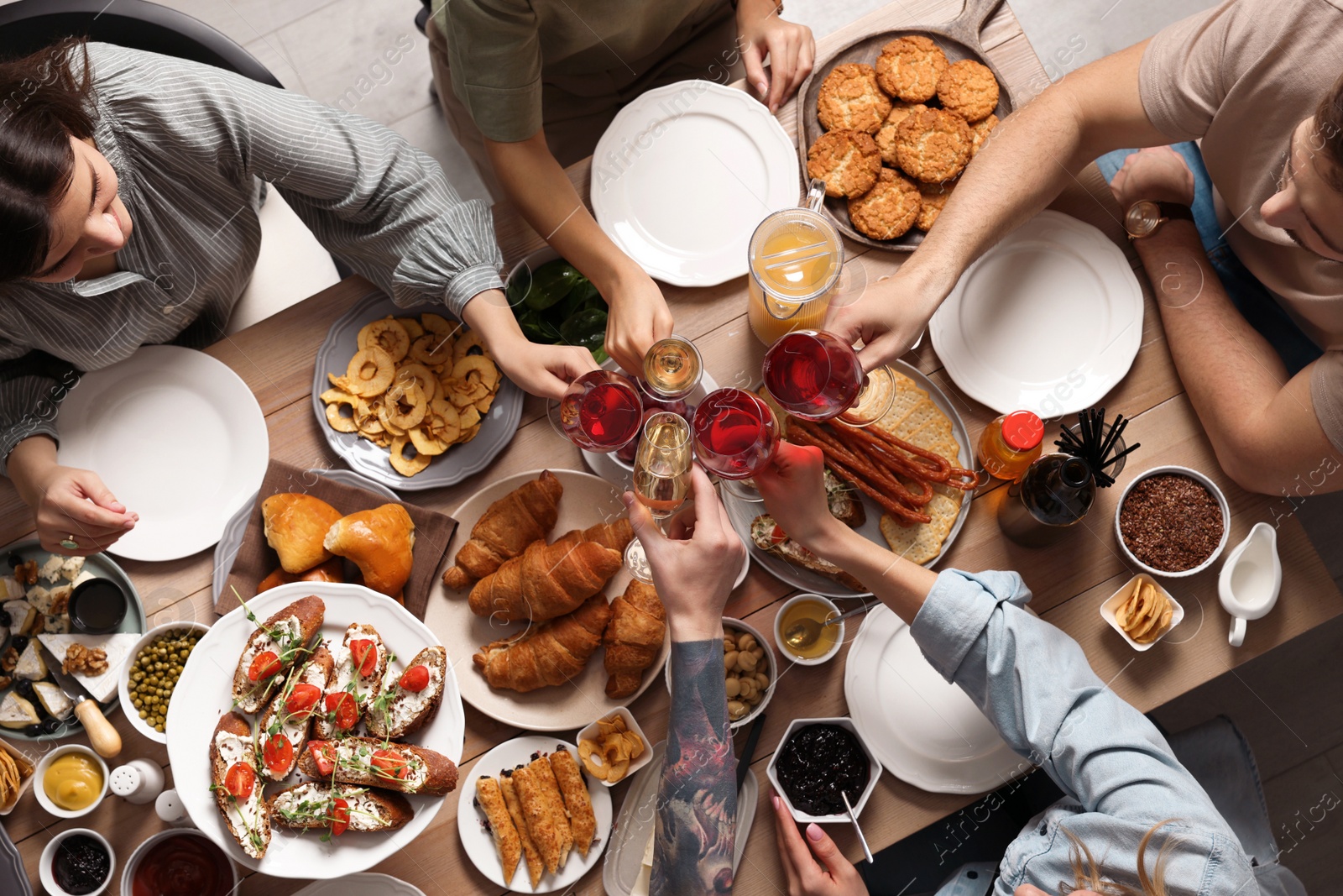 Photo of Group of people having brunch together at table, top view