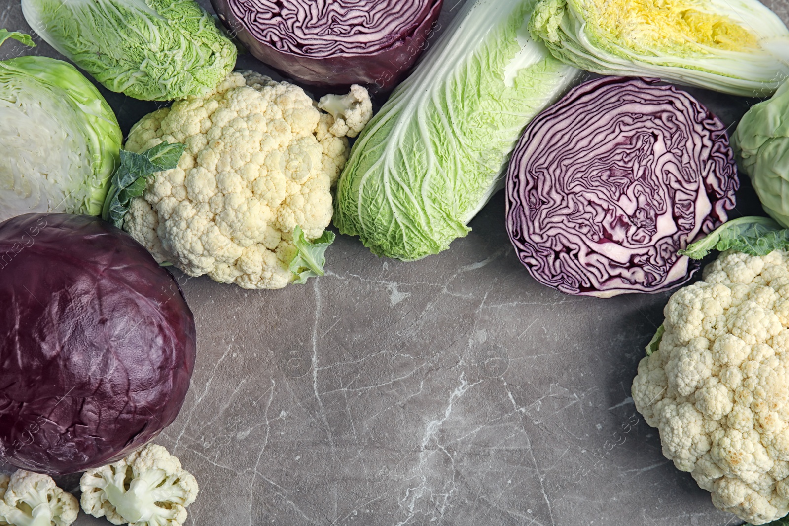 Photo of Flat lay composition with different cabbages on grey background