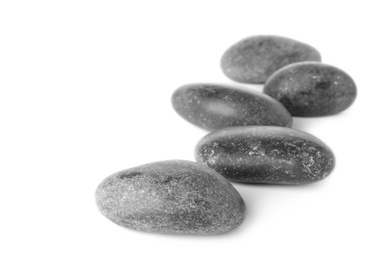 Photo of Many grey spa stones on white background