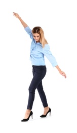 Full length portrait of businesswoman balancing on white background