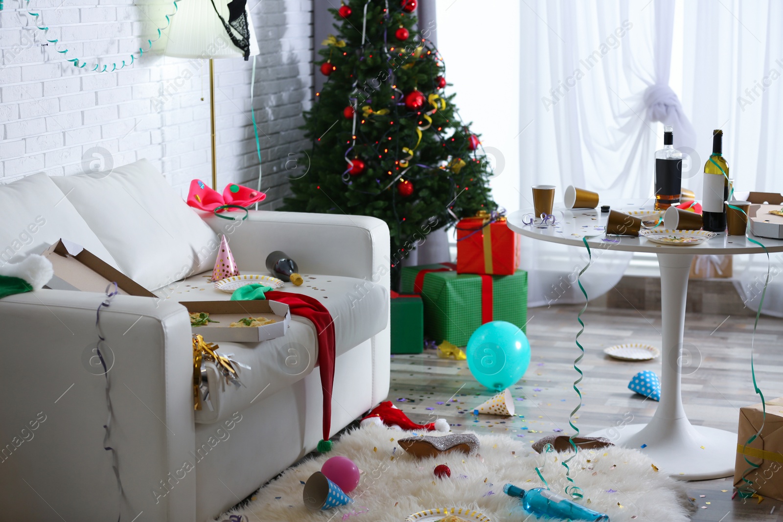 Photo of Messy living room interior with Christmas tree. Chaos after party