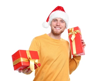 Photo of Young man with Christmas gifts on white background